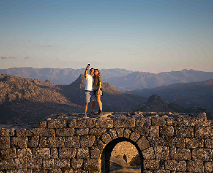 Couple taking a selfie atop a stone wall in Peneda-Gerês National Park